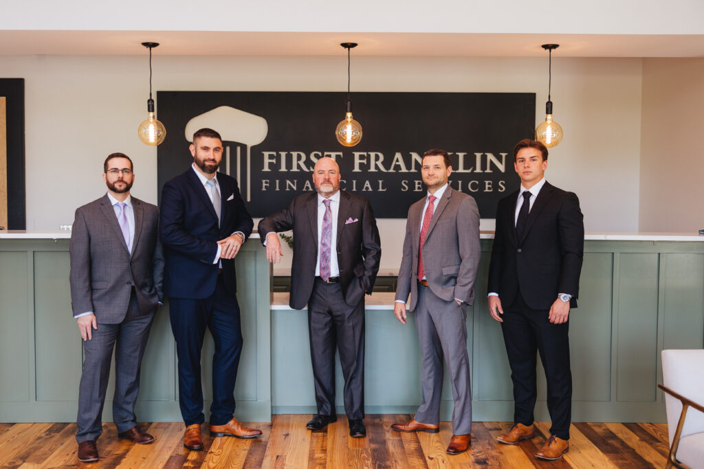 Brett Ewing standing with a group at First Franklin Financial Services.