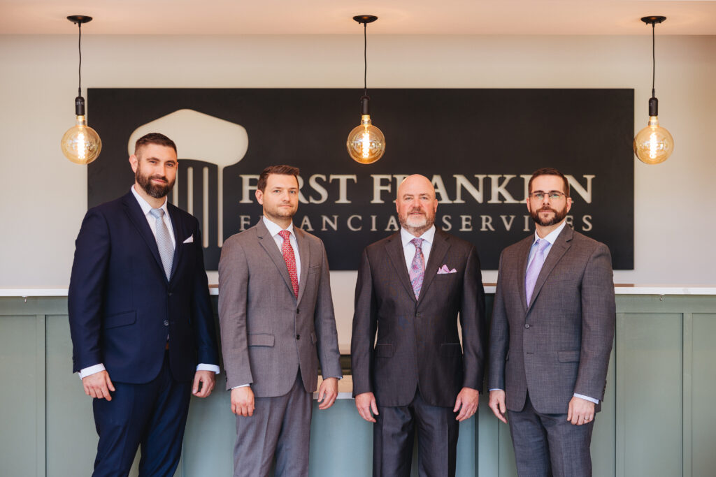 Brett Ewing standing with others inside First Franklin Financial Services.