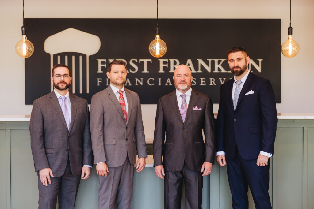 Brett Ewing pictured with several people at First Franklin Financial Services.