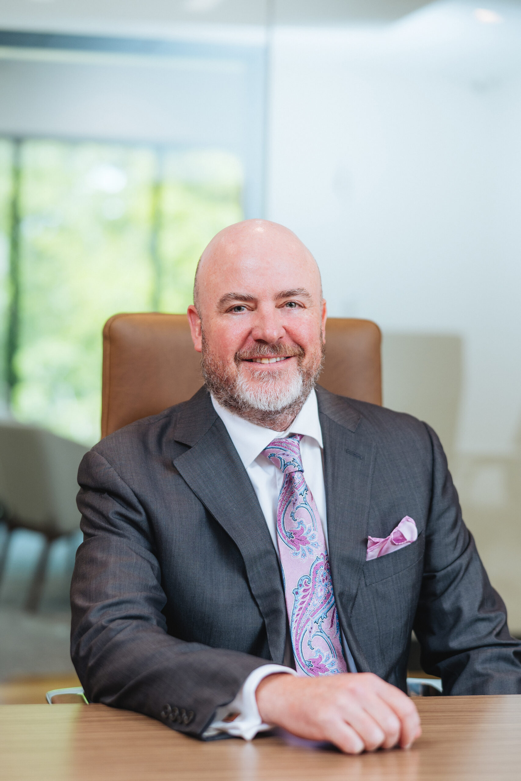 Brett Ewing seated for a professional financial advisor portrait.